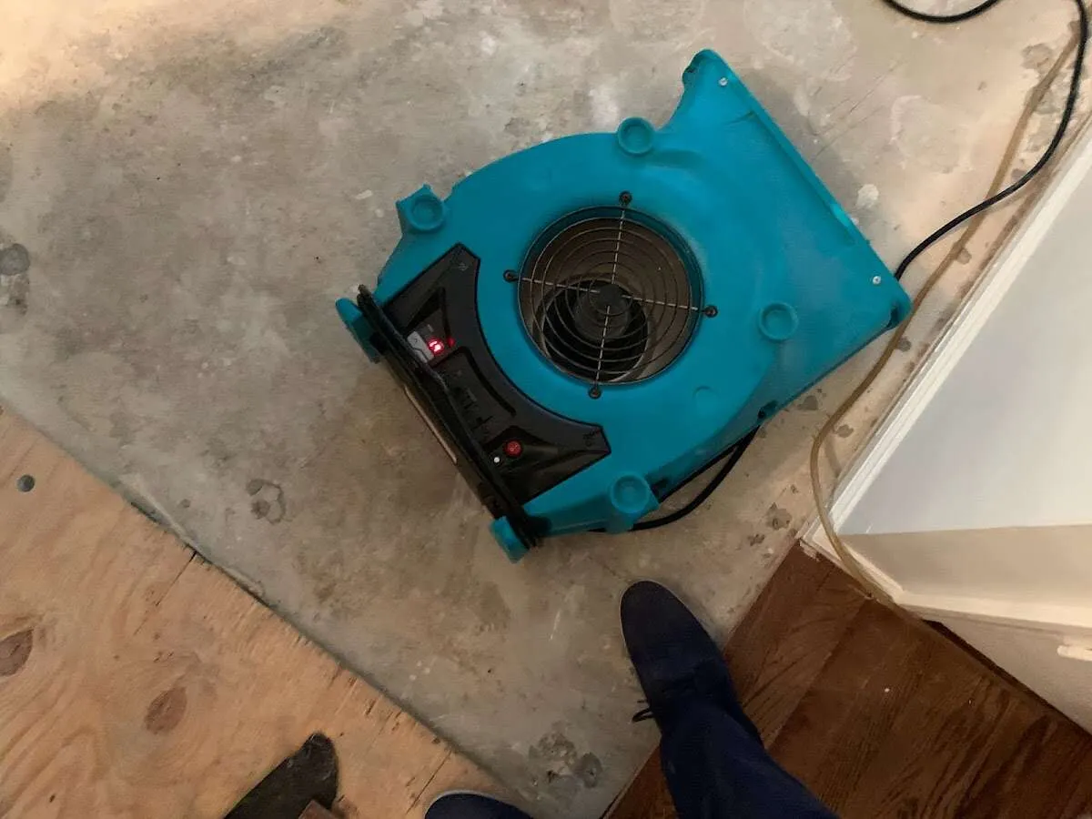 Air mover drying subfloor during Commercial Water Damage Restoration in Garden City